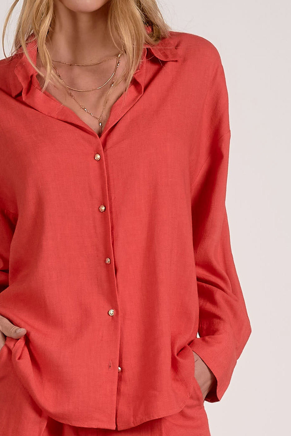 detailed view of red button down collared shirt