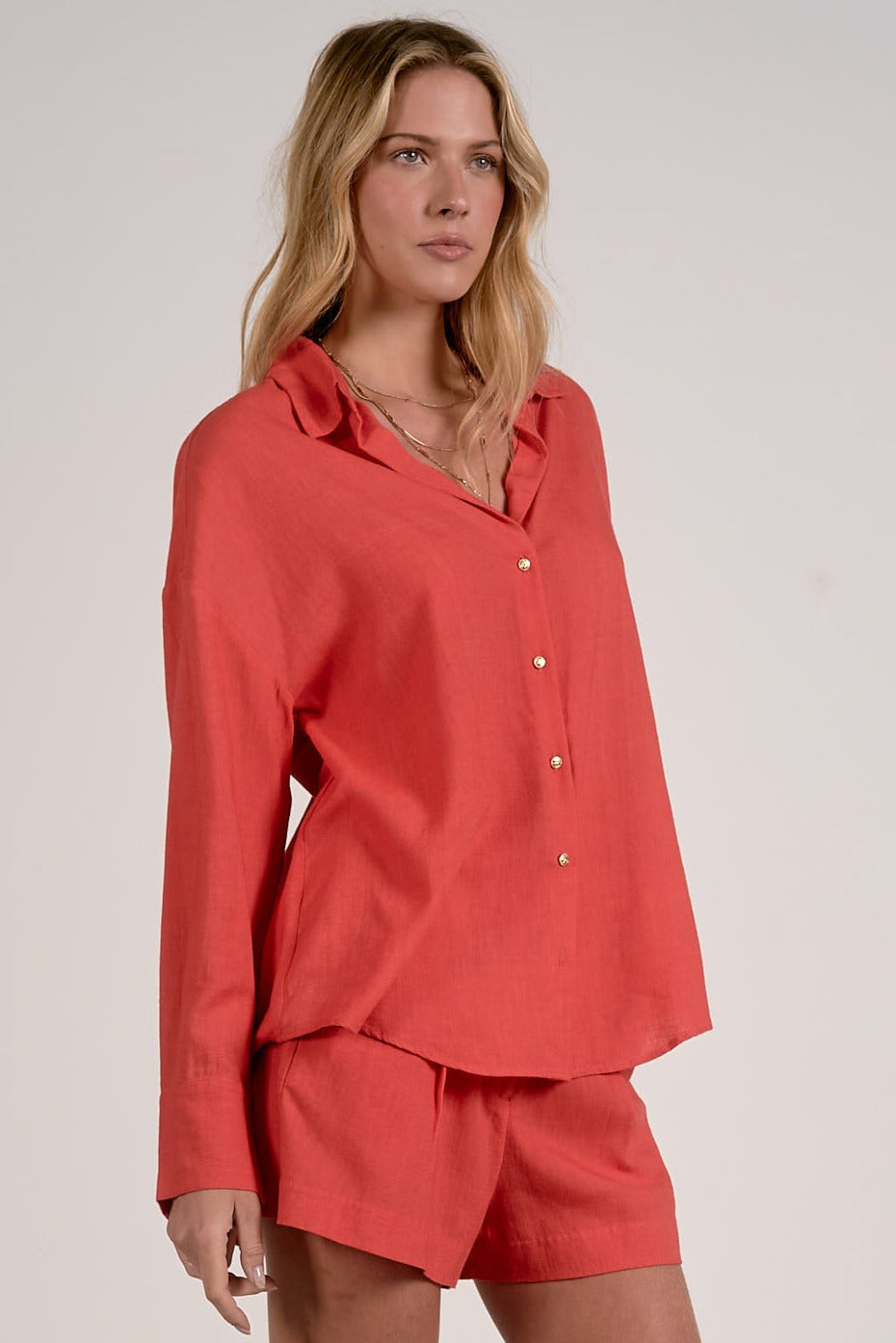 side view of red button down shirt women relaxed fit collared blouse gold buttons