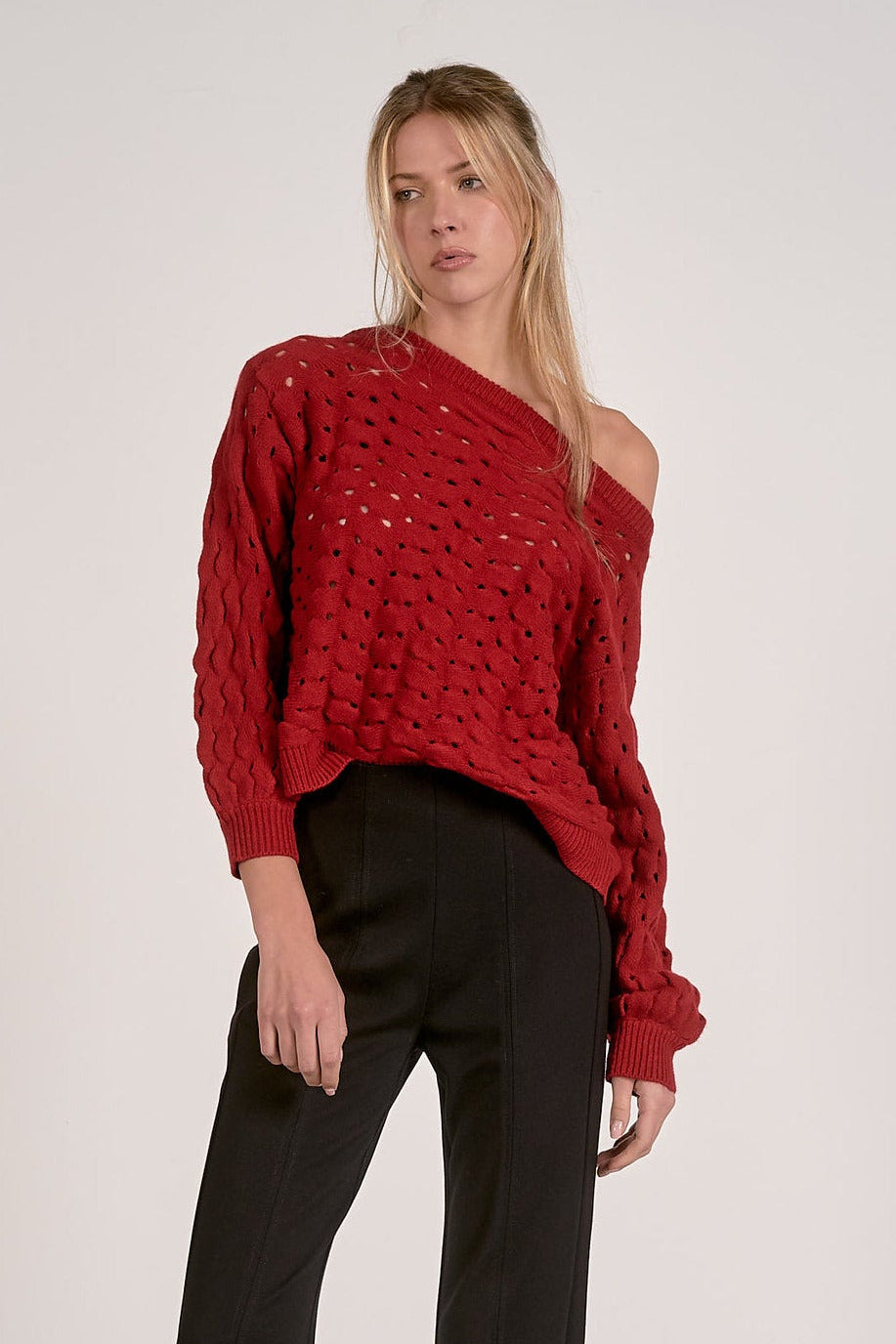 Relaxed fit open knit sweater styled casually with black trousers
