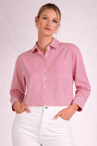 Red stripe button front top with collared neckline, button front closure, and front pocket detail paired with white denim