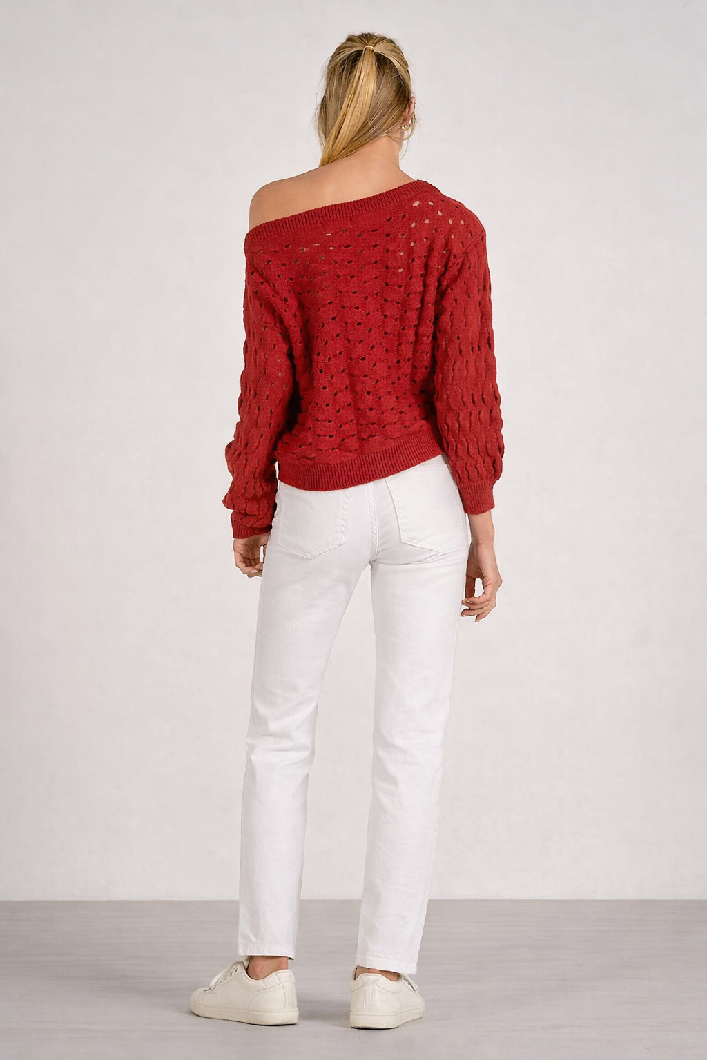 back of relaxed fit open knit sweater shown with white denim