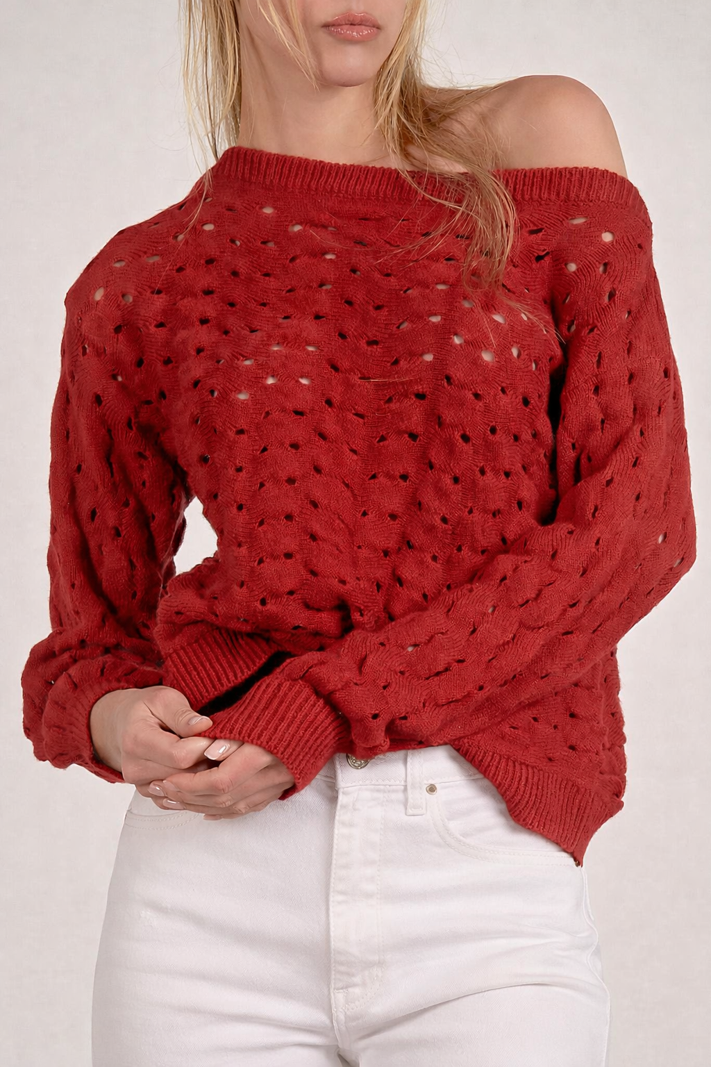 detail on red open stitch knit sweater with textured lightweight knit