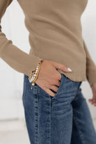 woman showing a close up of mac and me ribbed waffle top in tan with mac and me jeans