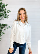 front of Mac and Me ivory ruffle collar sweater with blue lettuce trim worn with dark denim