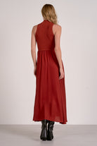Back of the rust mockneck sleeveless maxi dress with ribbed bodice, woven skirt, and high-low hem from Mainstream Boutique Bloomington