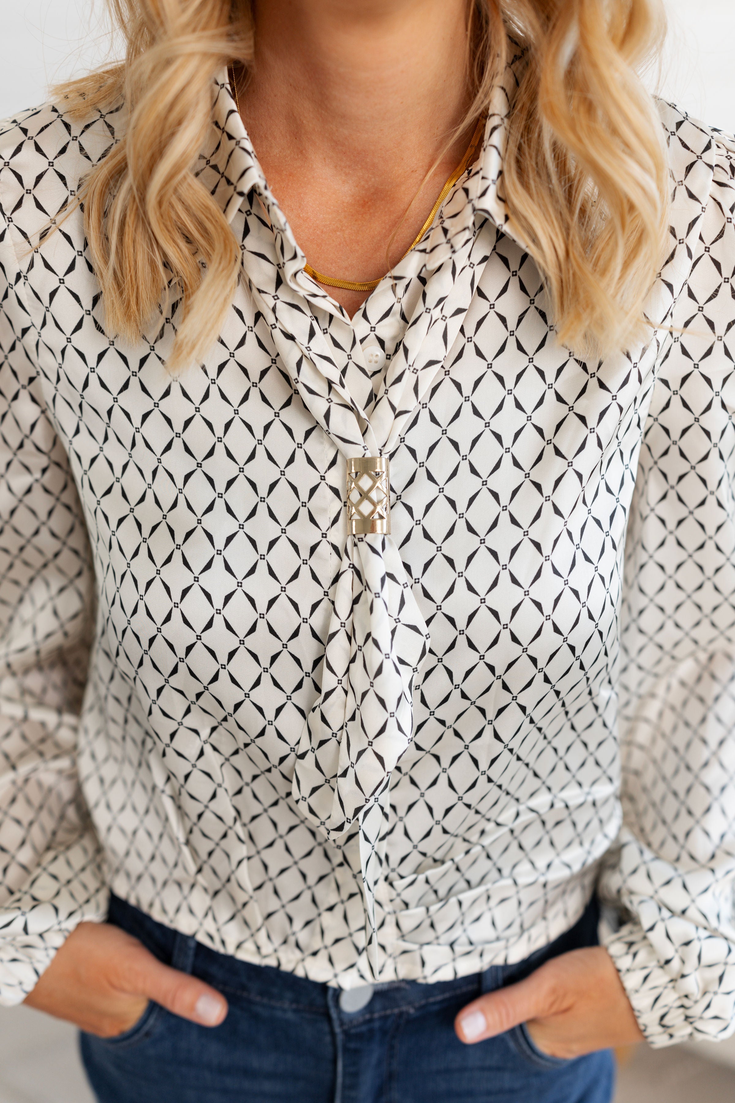 Showing the front of the Ivory Scarf Blouse with gold ring detail from Mainstream Boutique Bloomington