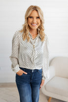 Woman modeling the Ivory Scarf Blouse with Gold Ring Detail from Mainstream Boutique Bloomington