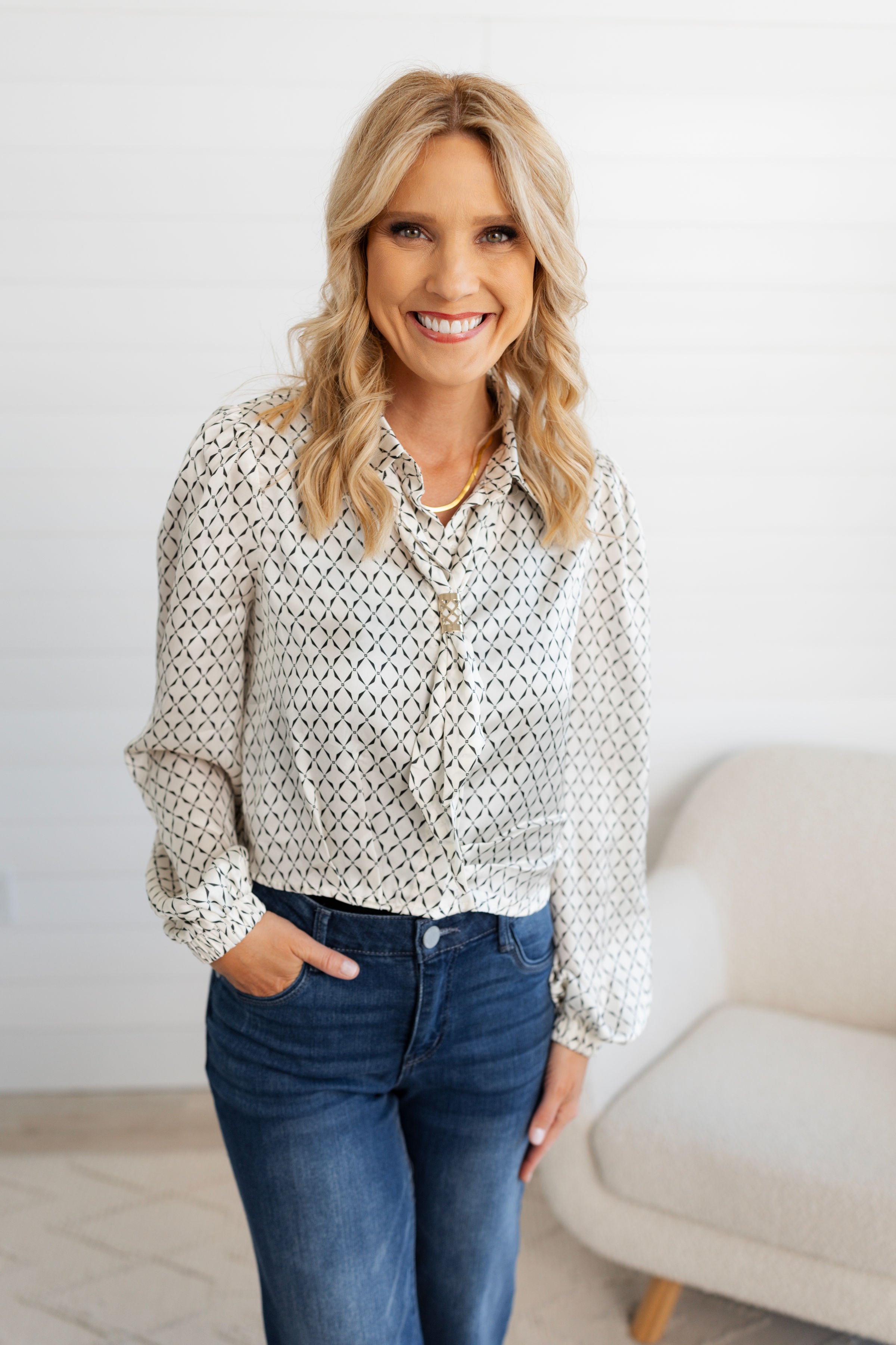 Woman modeling the Ivory Scarf Blouse with Gold Ring Detail from Mainstream Boutique Bloomington