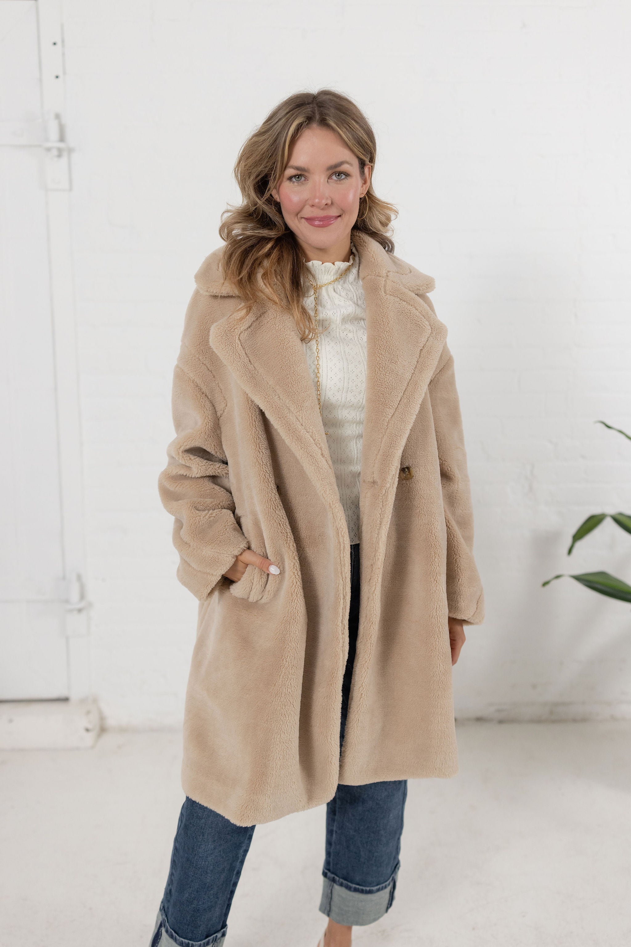 woman modeling the plush teddy coat in an oatmeal color from Mainstream Boutique Bloomington
