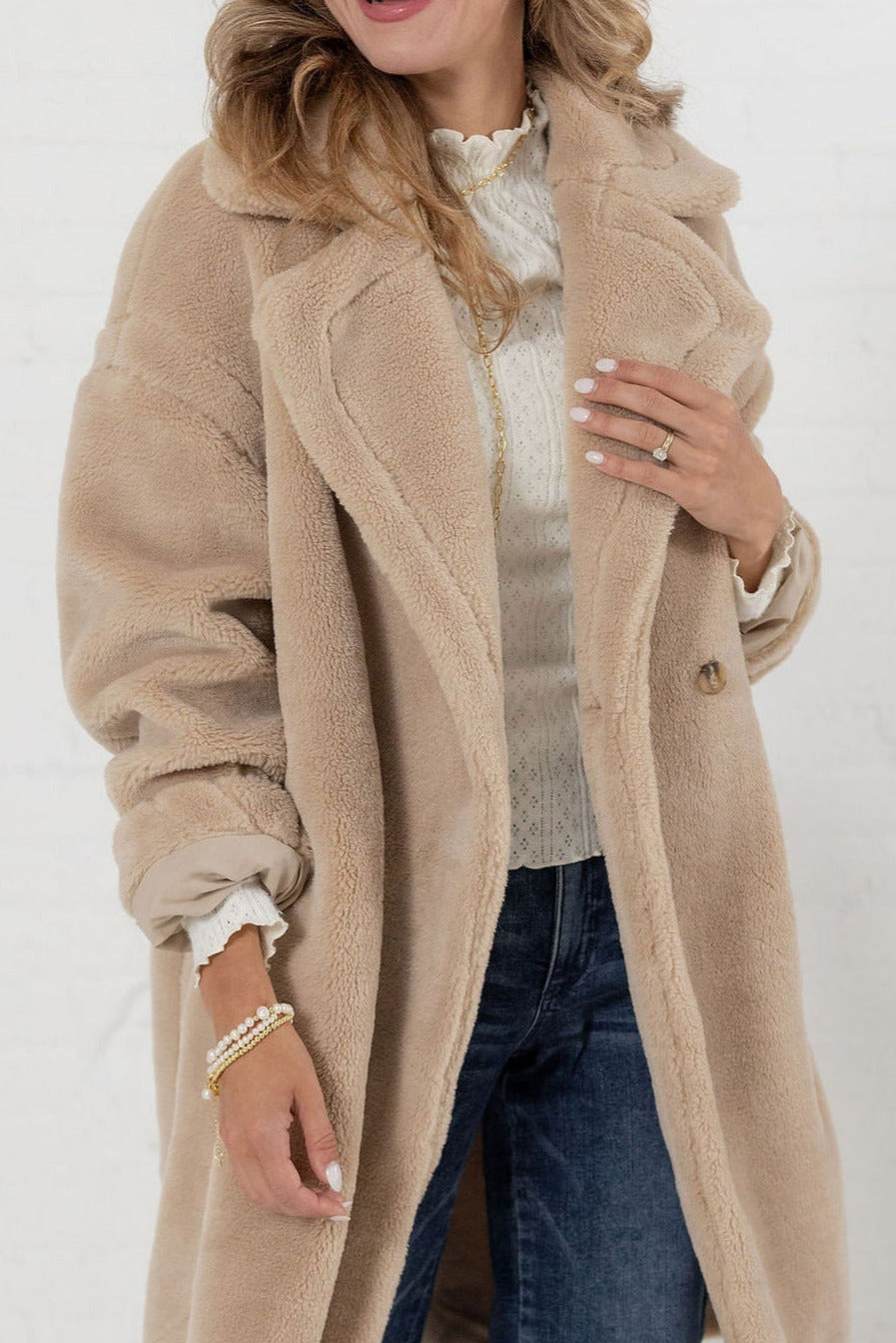 Close-up of plush faux shearling texture on oatmeal teddy coat