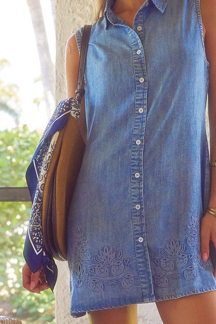 details of embroidery on button down shirtdress in chambray blue