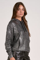 Model wearing silver Metallic Hoodie Sweater with relaxed fit and subtle shimmer from Mainstream Boutique Bloomington