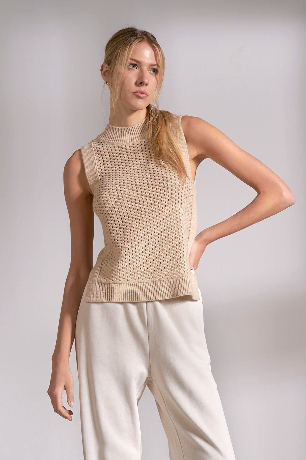 front of sand sleeveless knit sweater with textured design