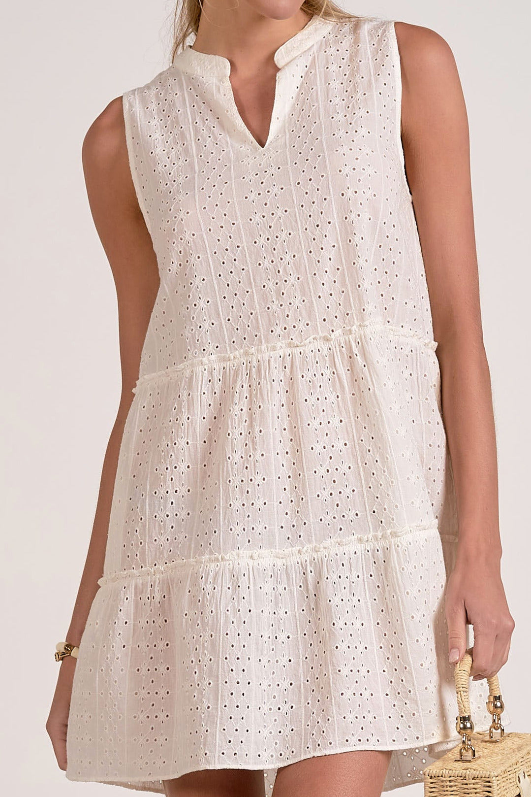 detailed view of eyelet mini dress in white