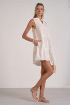 side view of sleeveless eyelet dress in white