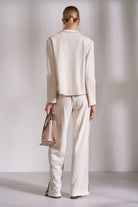 Back view of stone cotton knit blazer with relaxed structured fit