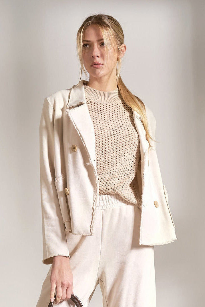 Stone double breasted knit blazer in neutral cotton with structured lapel and buttons