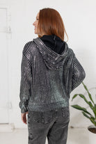 Model showing the back of the metallic knit sweater in silver from Mainstream Boutique Bloomington