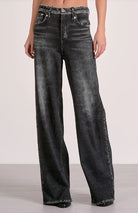 Front side of the sweatpant jeans finished in a  grey wash