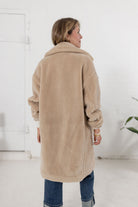 woman showing the back of the plush teddy coat from Mainstream Boutique Bloomington