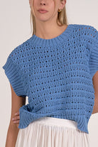 close up details on vibrant blue textured open knit cap sleeve sweater with ribbed trim