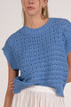 close up details on vibrant blue textured open knit cap sleeve sweater with ribbed trim