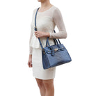 model showing the cross body attachment as a crossbody for the virginia satchel