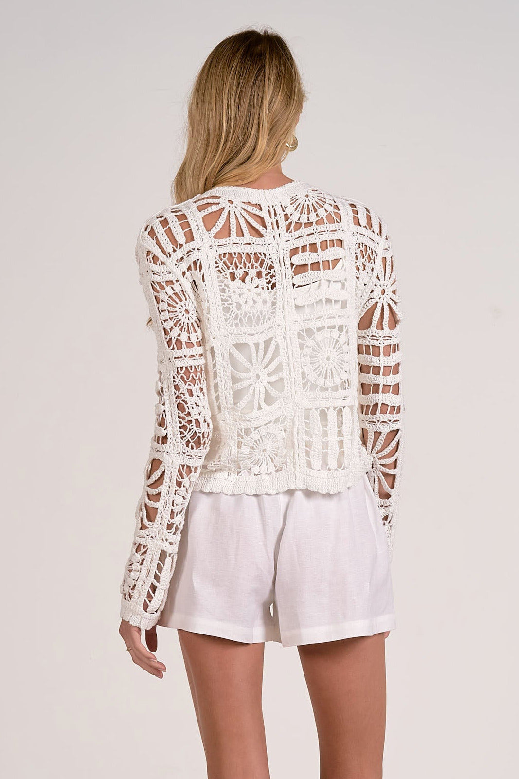 back view of white crochet cardigan